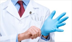 Doctor putting on a rubber glove